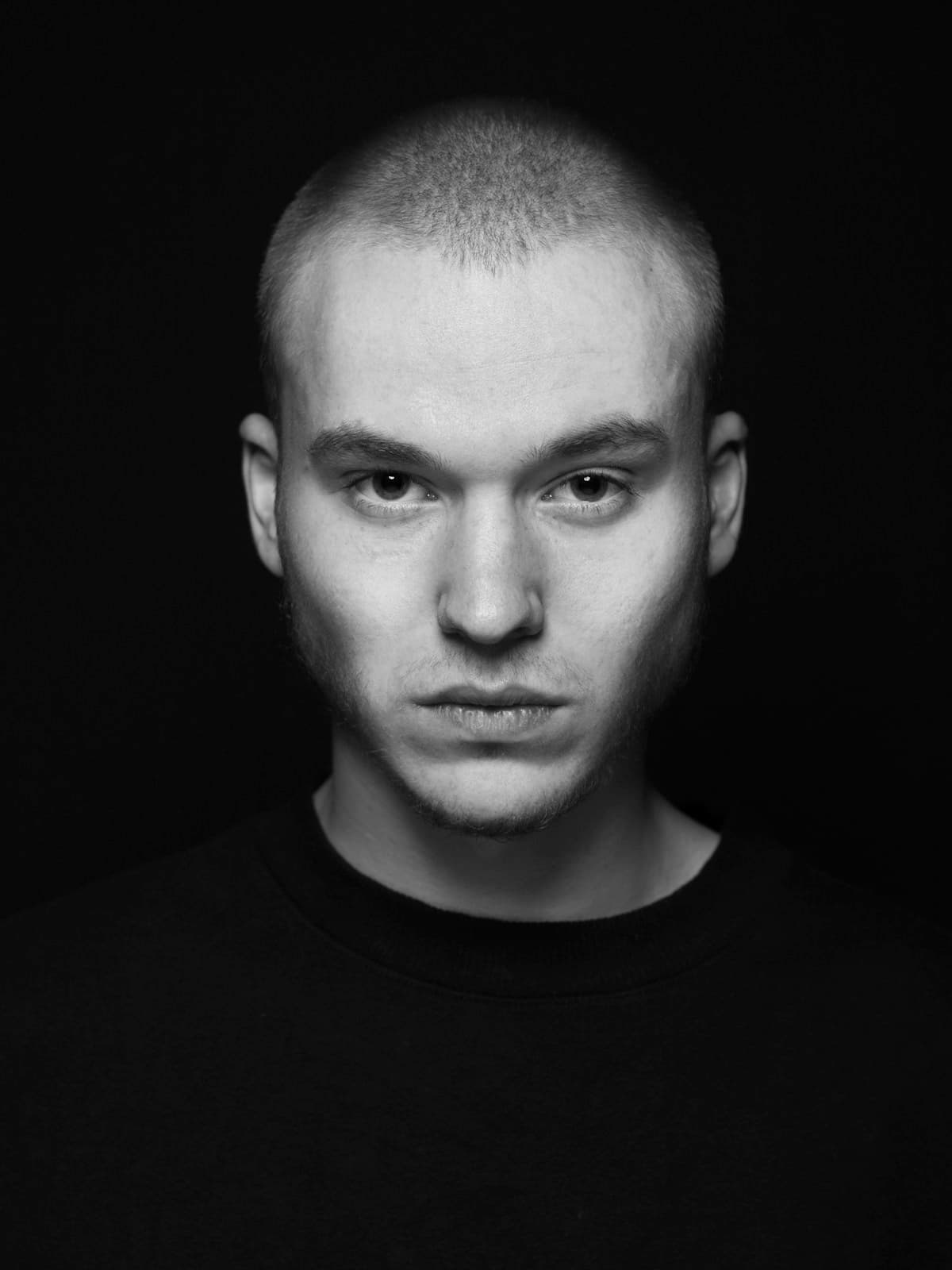 A dramatic low-key portrait of a single subject against black