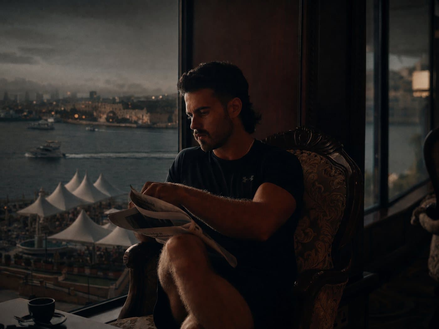 A member reading by the window, the harbour beyond