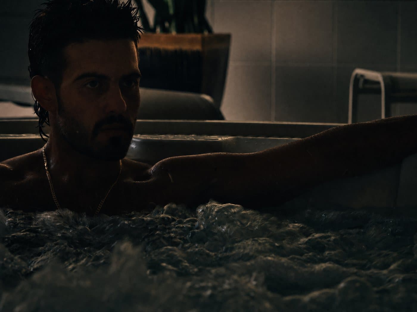 A member in the jacuzzi, water churning warm