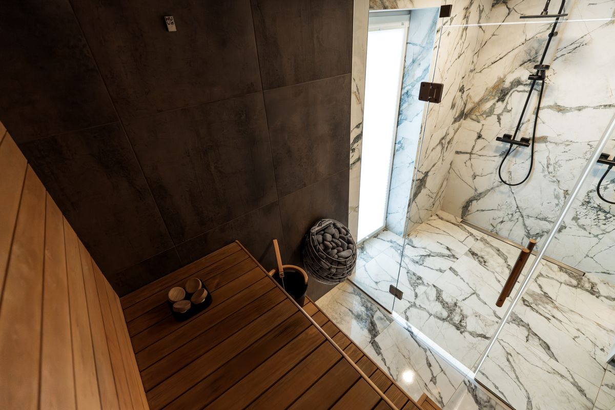 Contemporary Finnish sauna with marble shower in a modern wellness club