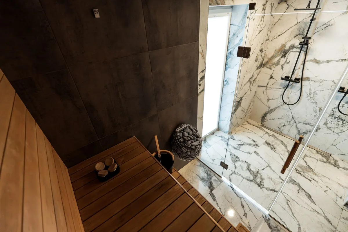Contemporary Finnish sauna with marble shower in a modern wellness club