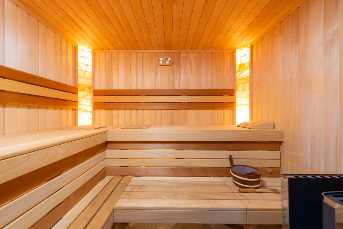 Finnish sauna at Pulse Wellness Club, boutique gym near Valletta Malta, wooden benches warm lighting