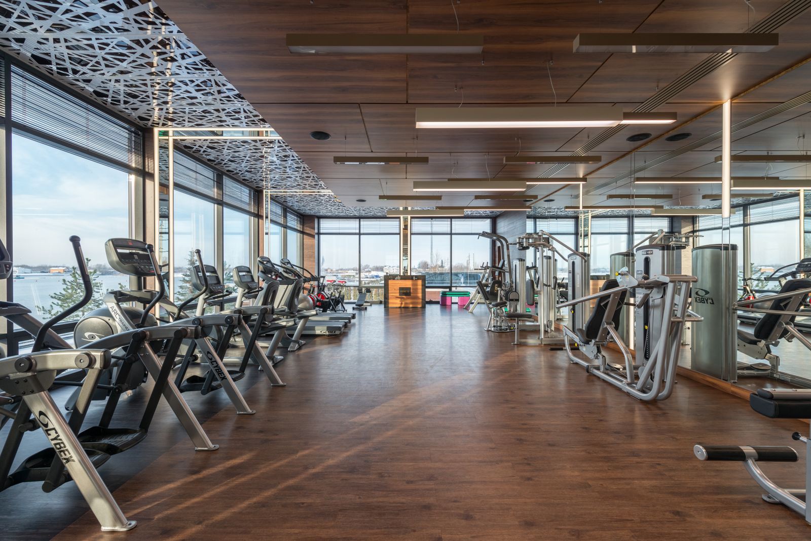 Spacious modern gym interior with fitness machines and panoramic windows, ideal for a structured lunch break workout