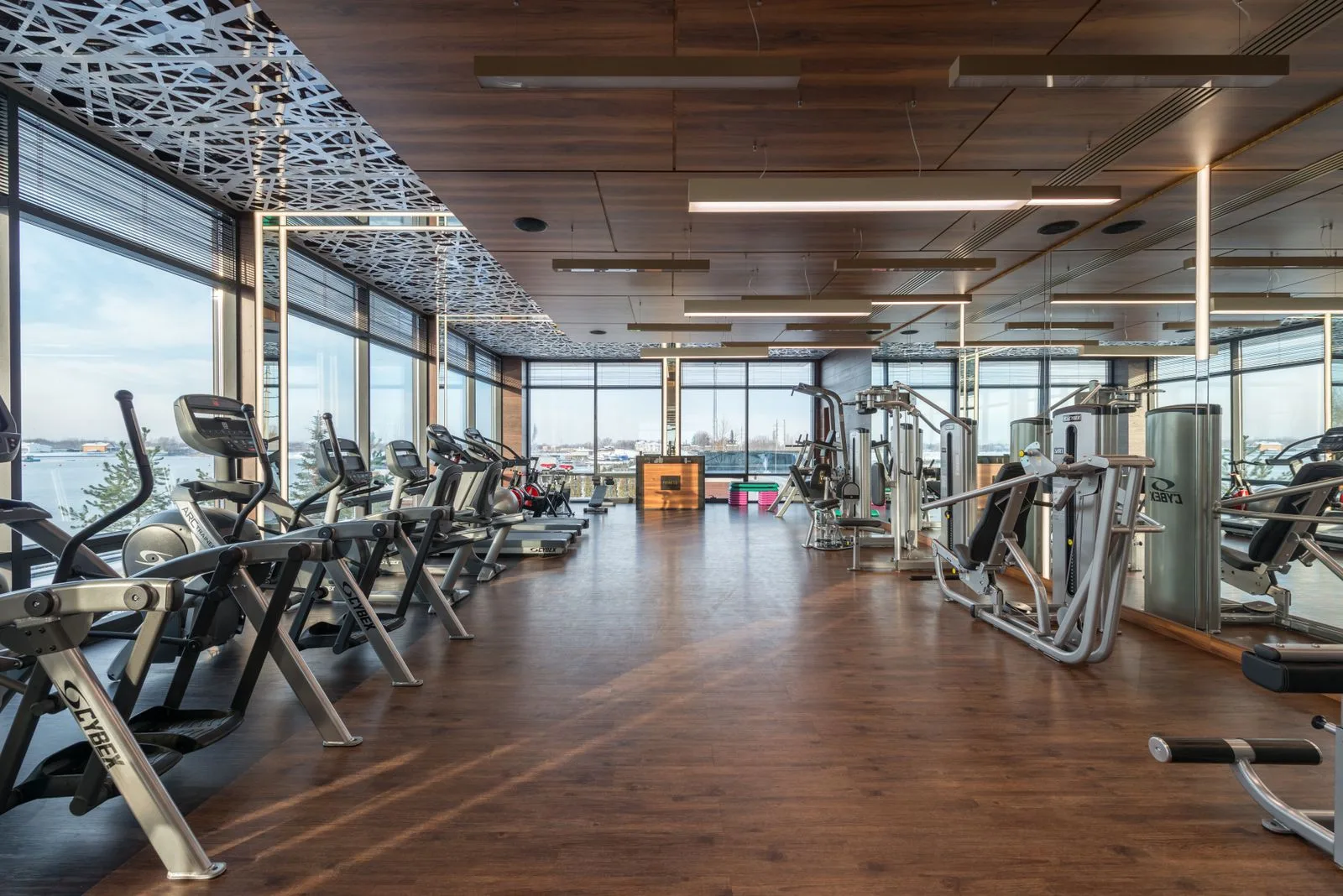 Spacious modern gym interior with fitness machines and panoramic windows, ideal for a structured lunch break workout