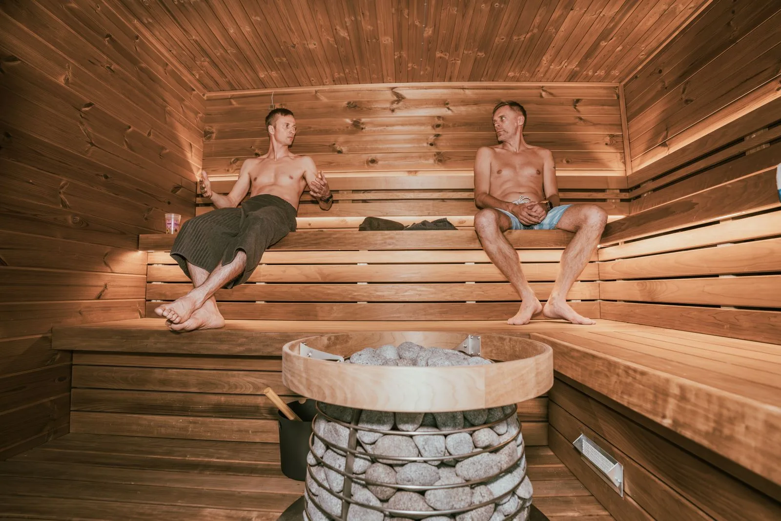 Two people relaxing in a Nordic sauna — Finnish sauna and recovery facilities at Pulse Wellness Club Malta