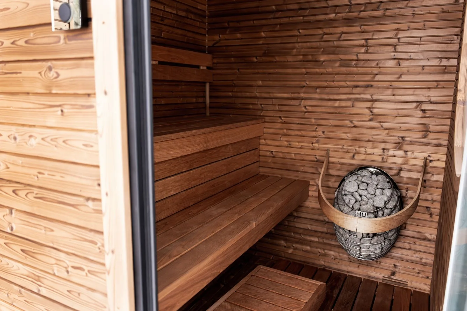 A wooden sauna interior, where heat therapy supports recovery and cardiovascular health