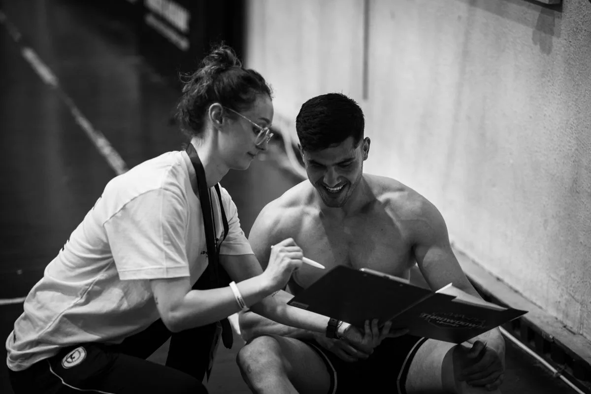 Personal trainer consulting with client in gym, choosing the right Malta gym membership
